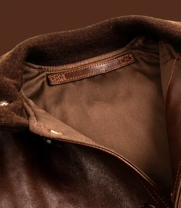 Close-up of a brown leather jacket collar and interior.
