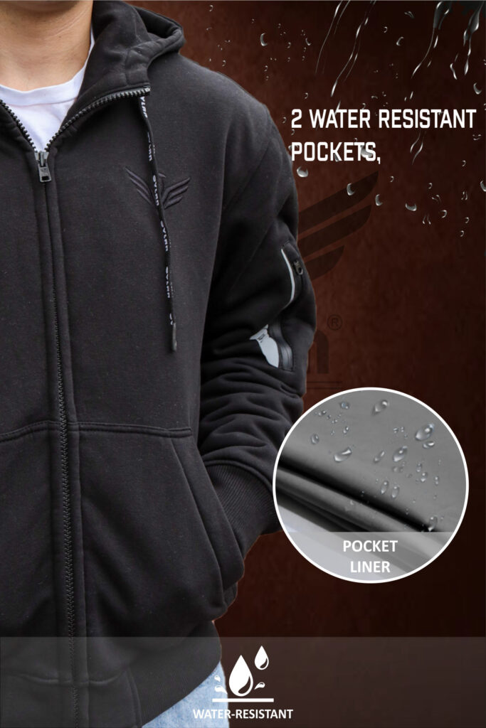lose-up of a man wearing a black zip-up hoodie with water-resistant pockets. A zoomed-in view shows the pocket liner with water droplets.