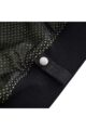 Close up of a snap button and dotted fabric on a black garment.