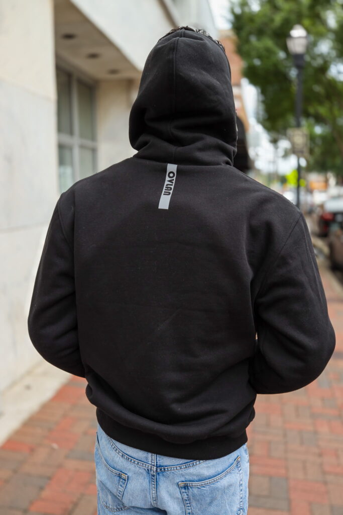 Back view of a man wearing the OVLAN CE Armored Motorcycle Hoodie in black