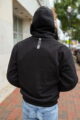 Back view of a man wearing the OVLAN CE Armored Motorcycle Hoodie in black
